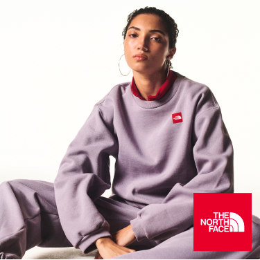 A guy in blue jacket leans on a woman in purple crewneck. 