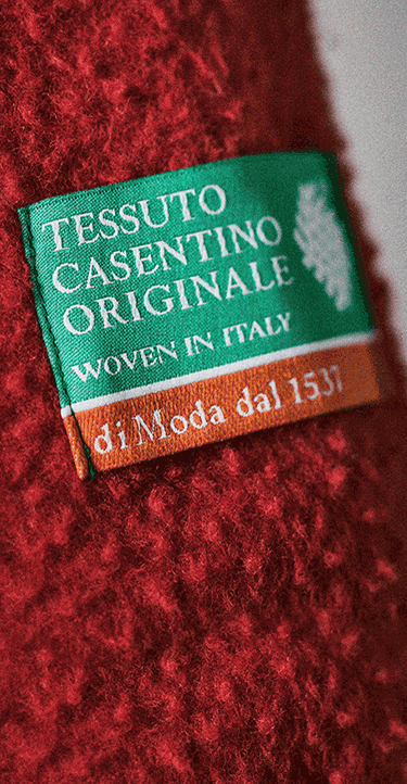 Close‑up views of a red 1995 Casentino Denali Jacket by The North Face. On the left is a detailed shot of a green woven label reading “Tessuto Casentino Originale Woven in Italy,” sewn onto the red textured fleece.