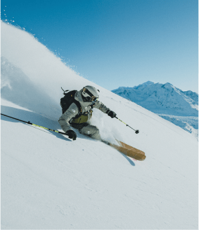 A person skiing down fresh powder.