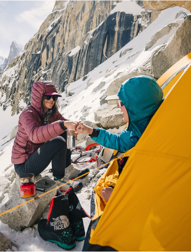 A picture from the vantage point of being inside your tent and looking out to a snowy mountain landscape.
