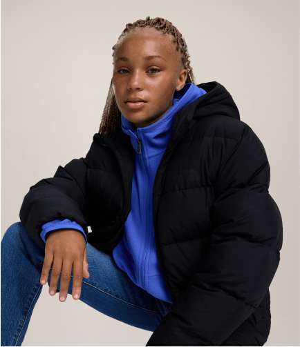 A young girl wearing a puffy jacket from The North Face