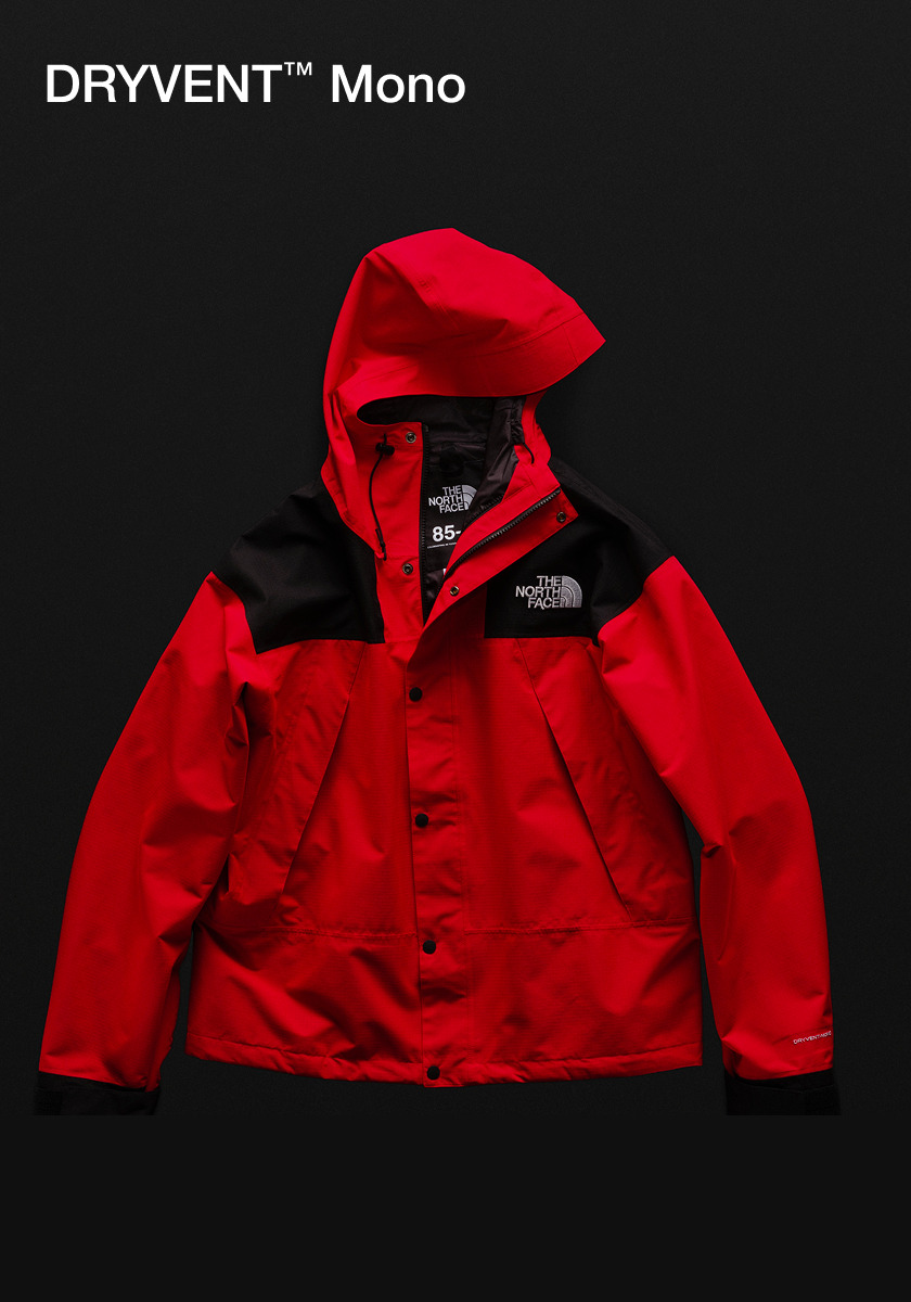Studio laydown shot of a The North Face DRYVENT Mono Mountain Jacket. Text: DRYVENT™ Mono.