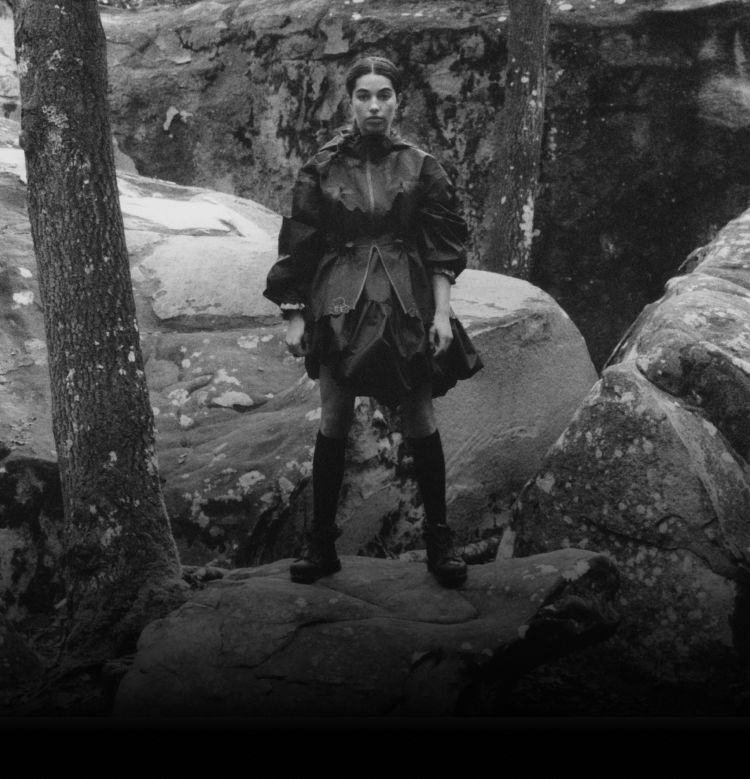 The North Face Athlete Brooke Raboutou is standing in the forest wearing gear from the The North Face x Cecilie Bahnsen collection.