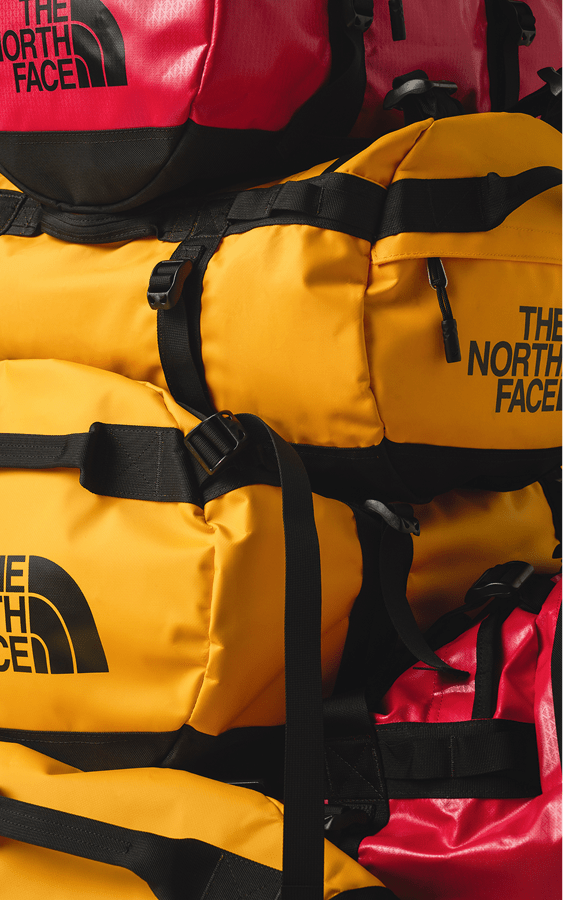 Two people atop a mountain in their The North Face gear.