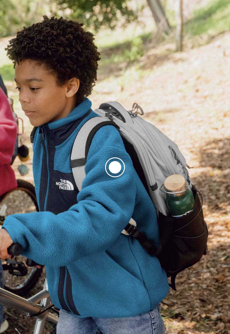 A boy wearing a grey Borealis backpack from The North Face