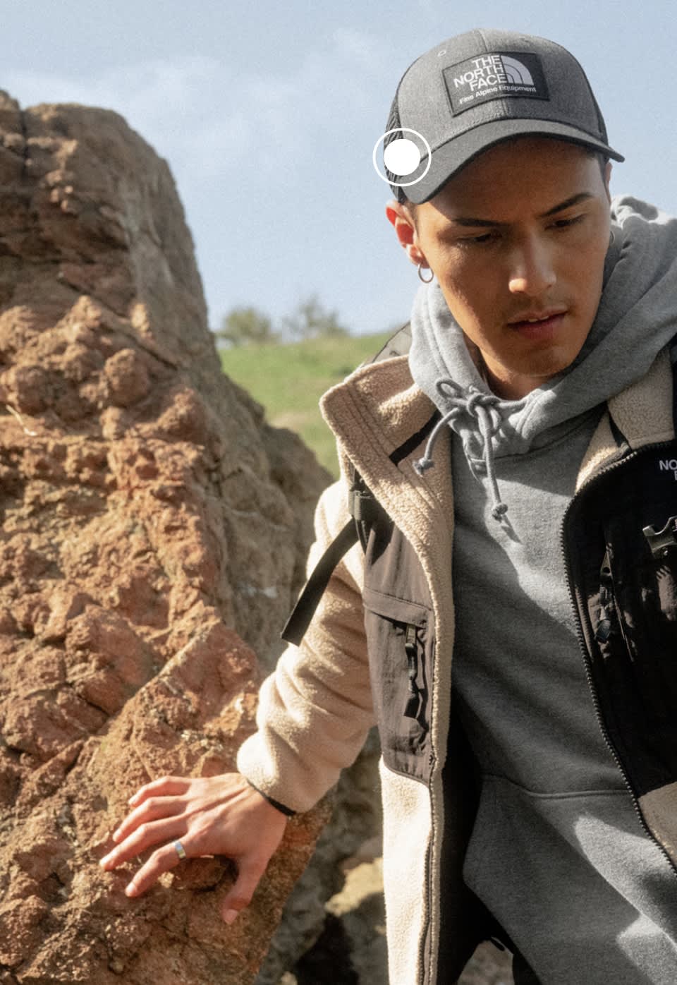 A man wearing a grey Mudder Trucker hat from The North Face