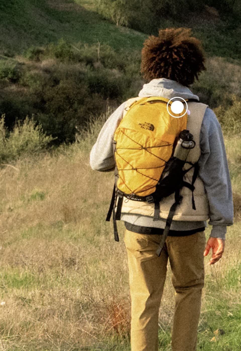 A man wearing a Summit Gold Borealis backpack from The North Face
