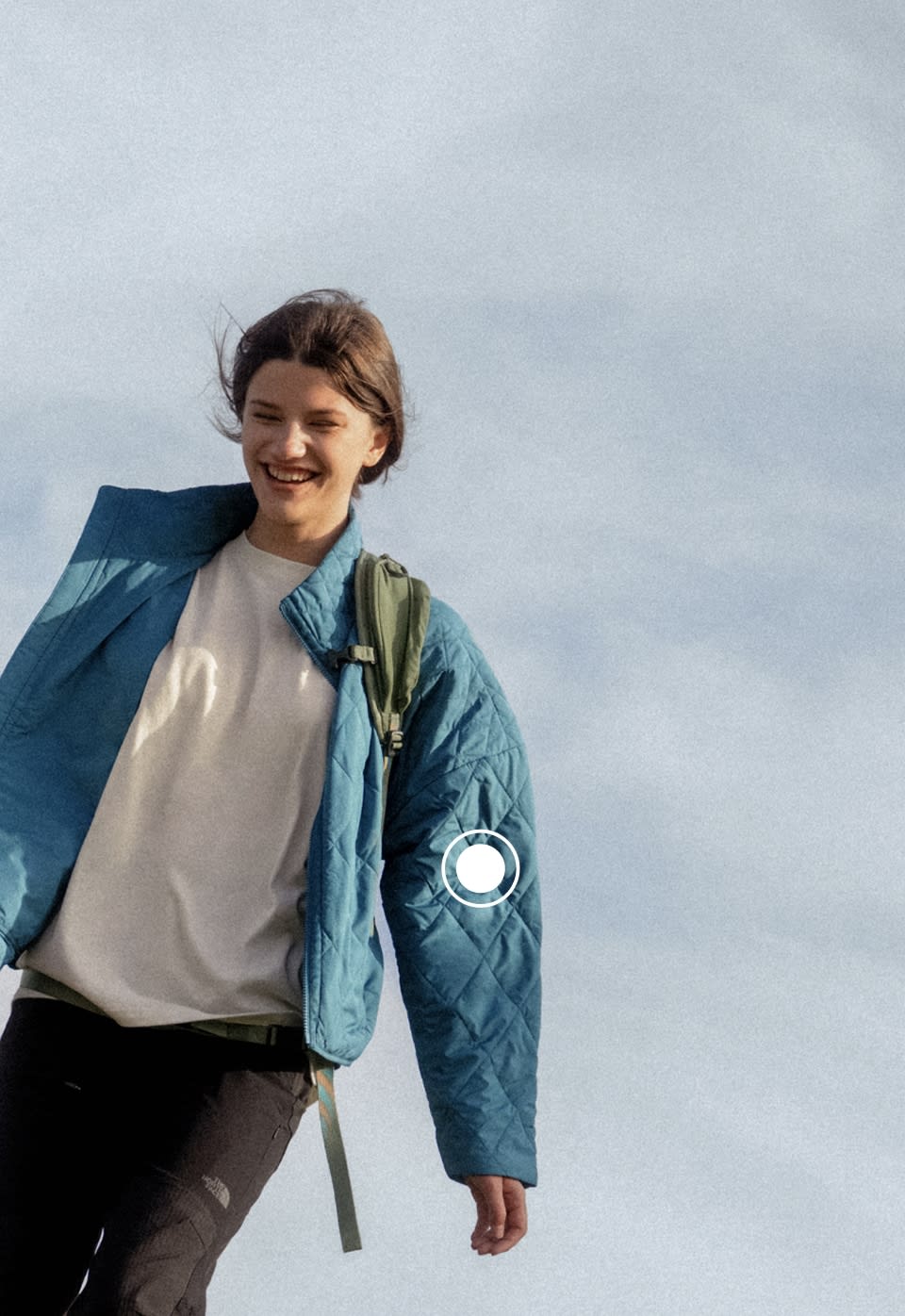 A woman wearing a blue Diamond Peak jacket from The North Face
