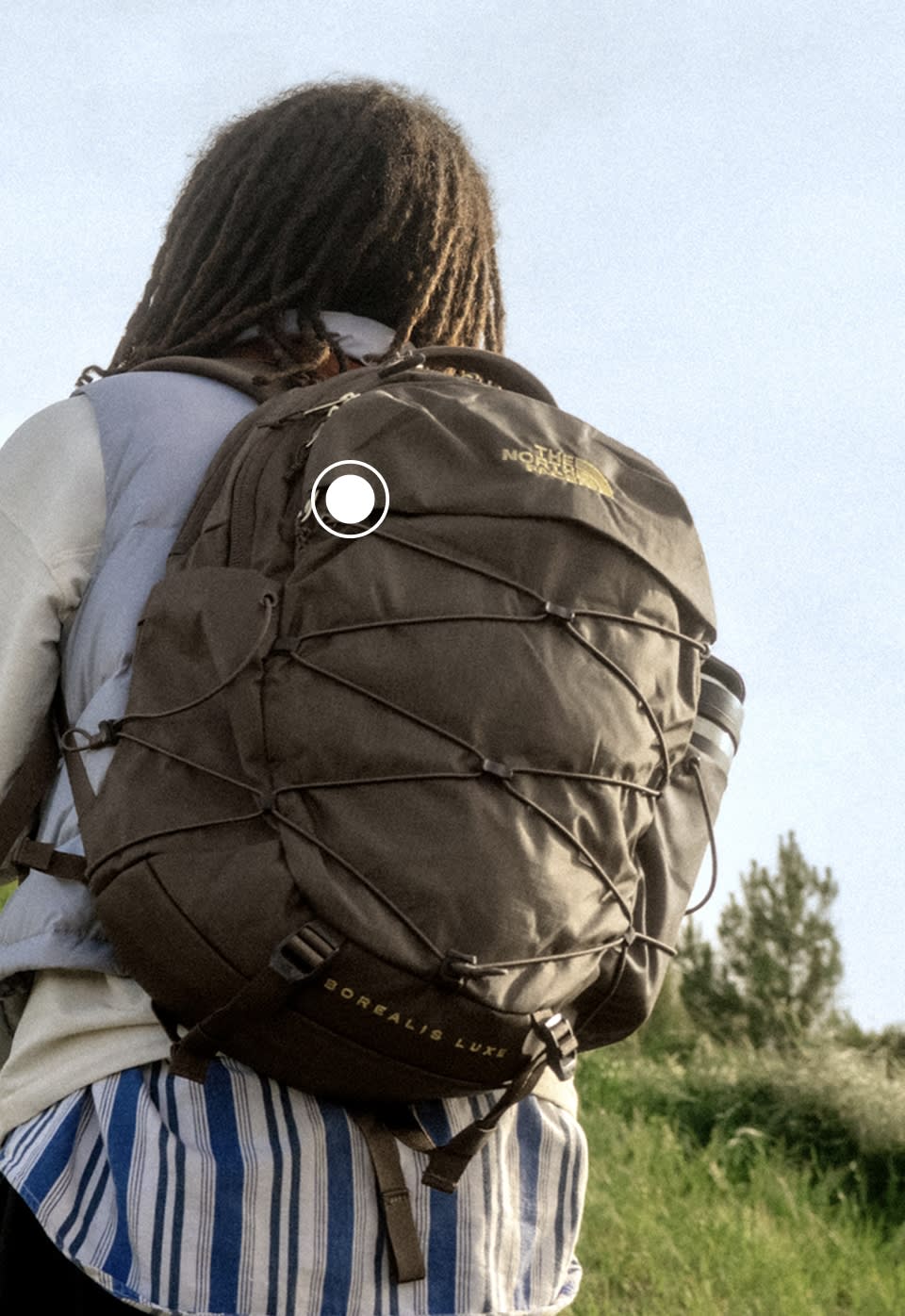 A woman wearing a brown Women's Borealis backpack from The North Face