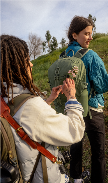 A backpack from The North Face in the grass.