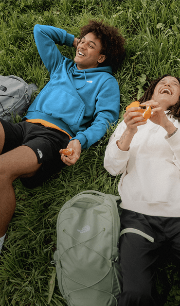A backpack from The North Face in the grass.