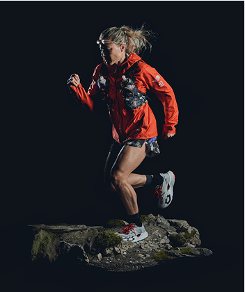 A hiker in The North Face gear sits on a rock.