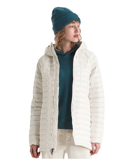 A woman wearing a white Thermoball jacket from The North Face