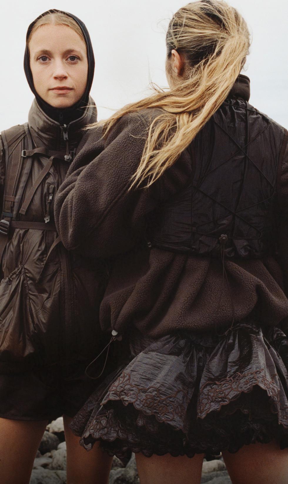 On the left: A woman in brown looking at the camera. On the right: A woman in brown with her back to the camera.