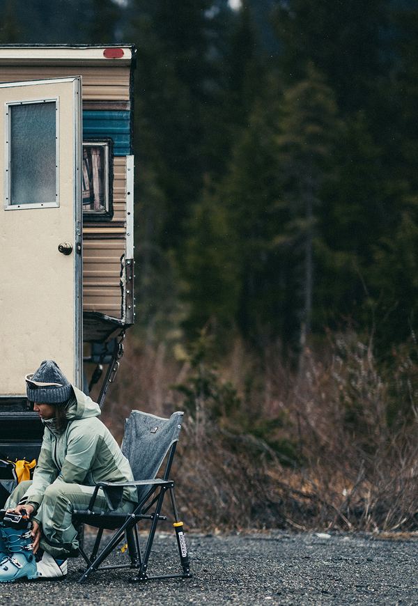 wo people walk toward the slopes, carrying The North Face Base Camp Boot Pack in Summit Gold and Base Camp Snow Roller.