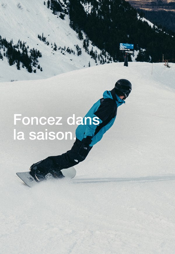 Two snowboarders ride down a snowy mountain, the woman wearing The North Face Women’s THERMOBALL™ Snow Triclimate® Jacket in Sumac/Mars Dust. A third image shows them hiking uphill with their boards in hand, surrounded by fresh powder and mountain views. 