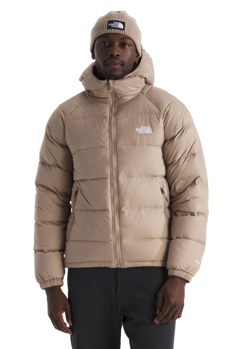 A guy in a tan Hydrenalite™ Down Hoodie with a matching beanie. 