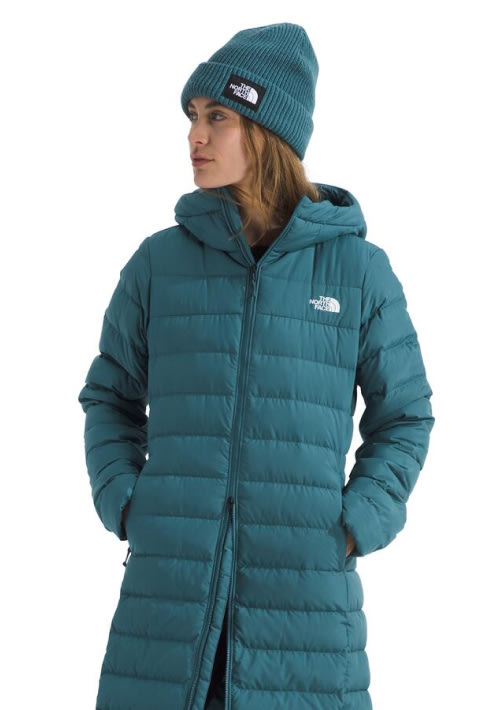 A woman in a blue Aconcagua Parka with a matching beanie.