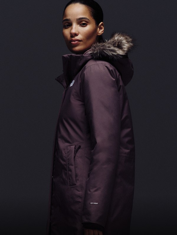 Female model looking stoic, wearing Arctic Parka in Tawny Quartz.
