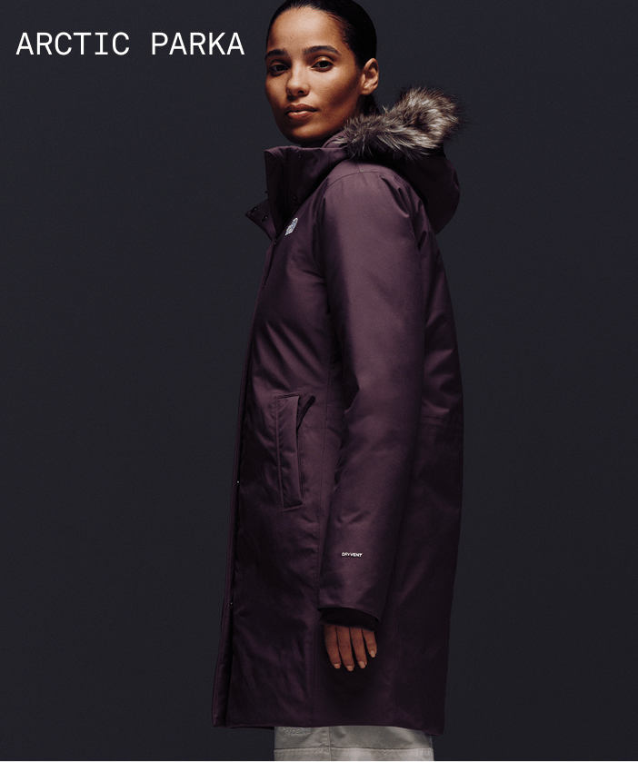 Female model looking stoic, wearing Arctic Parka in Tawny Quartz.