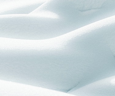 Soft rolling snow hills behind text