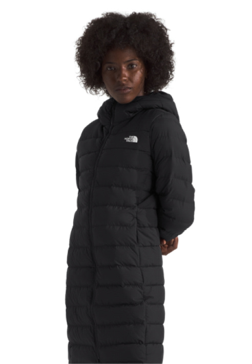 A woman in a black Aconcagua Parka with a matching beanie.