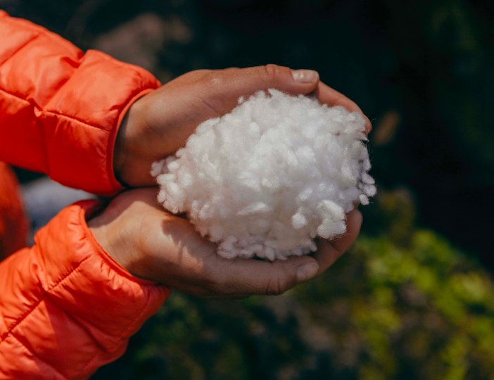 A person holding insulation material.