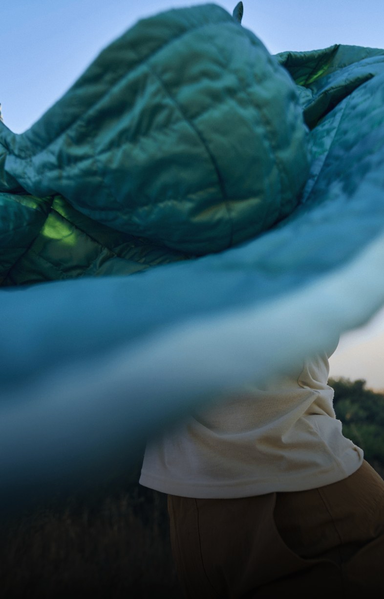 Person holding a jacket from The North Face in the wind