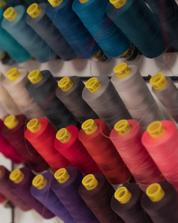 Multiple spools of colorful yarn in storage