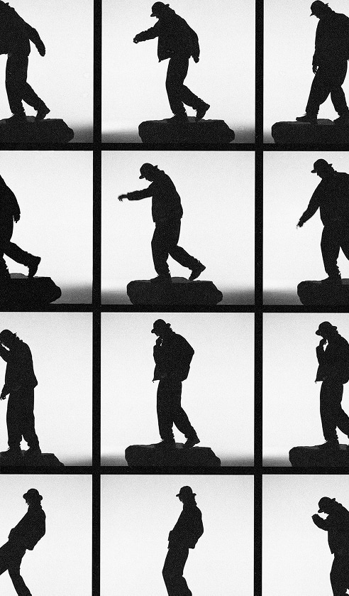 Different black and white portraits of a guy standing on a rock.