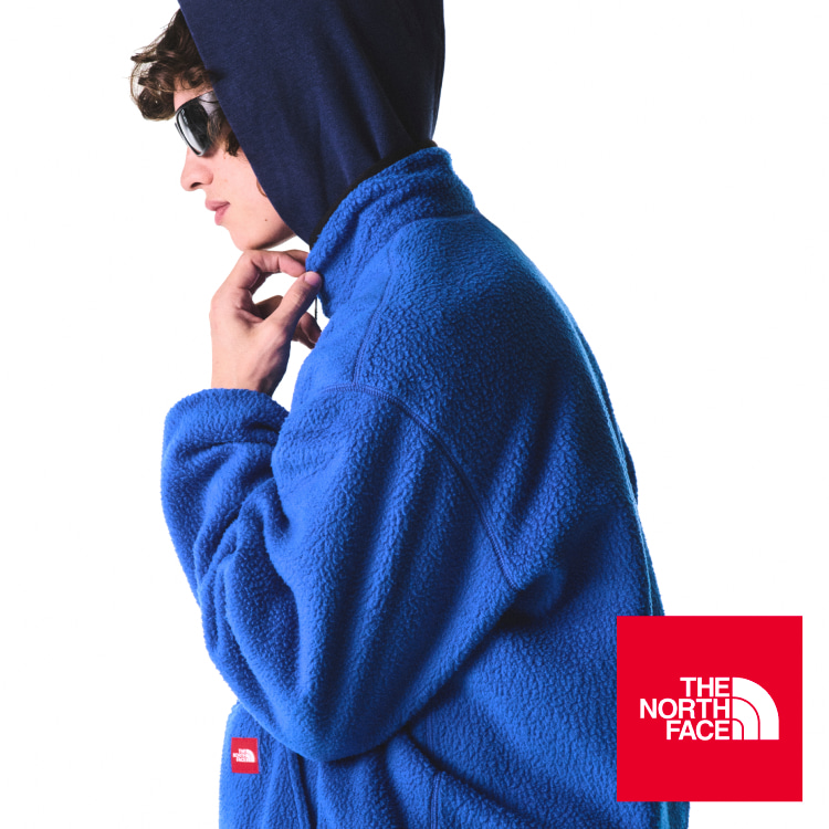 A guy in blue jacket leans on a woman in purple crewneck. 