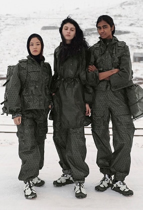 Three models wearing The North Face x Cecilie Bahnsen collection with Anna Base Camp Duffel bags.