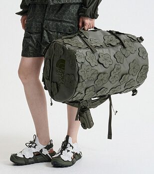 Model carrying the Anna Base Camp Duffel featured in The North Face x Cecilie Bahnsen collection.