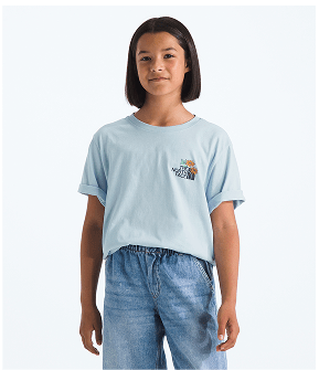 Girl wearing a blue t-shirt and blue jeans with arms at sides, smiling slightly and facing the camera. 