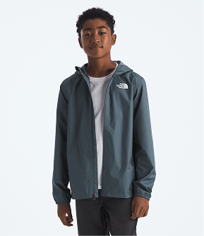 Boy wearing slate-colored jacket, white shirt and black pants with arms at sides, smiling slightly and facing the camera. 