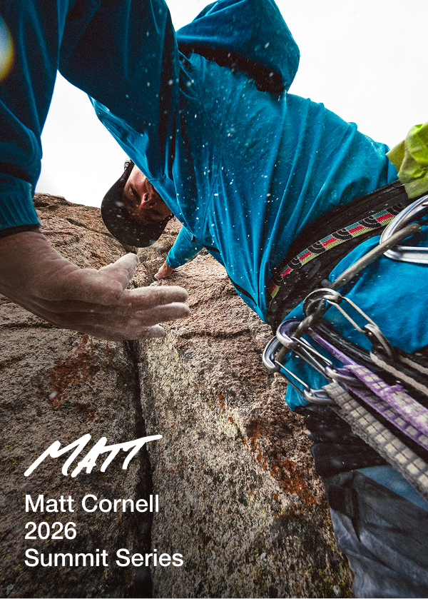 Athlete Matt Cornell setting up climbing gear on a boulder.