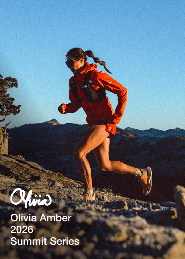 Person wearing Summit Series apparel running on mountain terrain. 