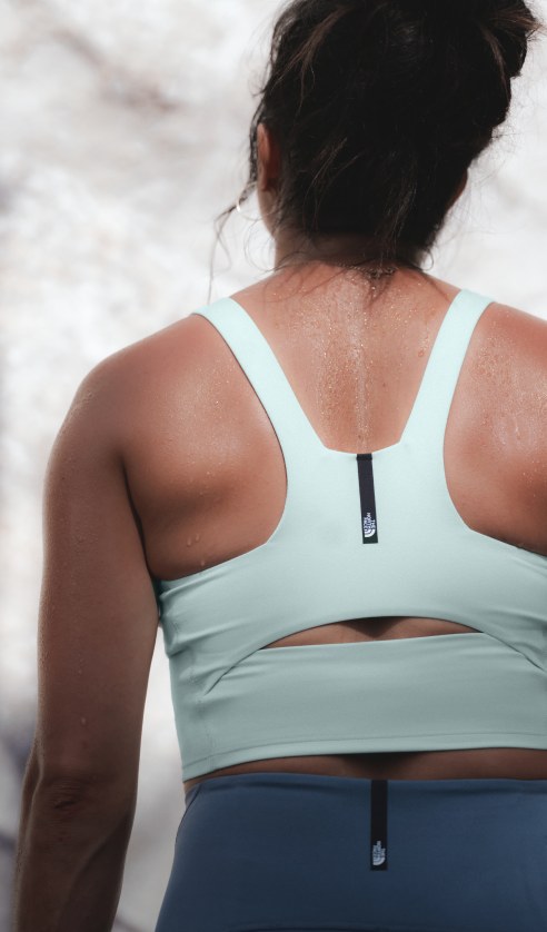Close-up back view of the Jaida Long Line Bra in Opal Frost paired with the Jaida Pocket Leggings in Granite Grey, highlighting fit and fabric texture.