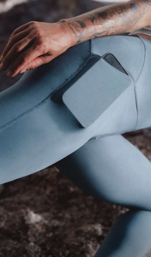 Close-up of an athlete wearing Jaida Pocket Leggings in Granite Grey, highlighting the side pocket and stretch during movement.