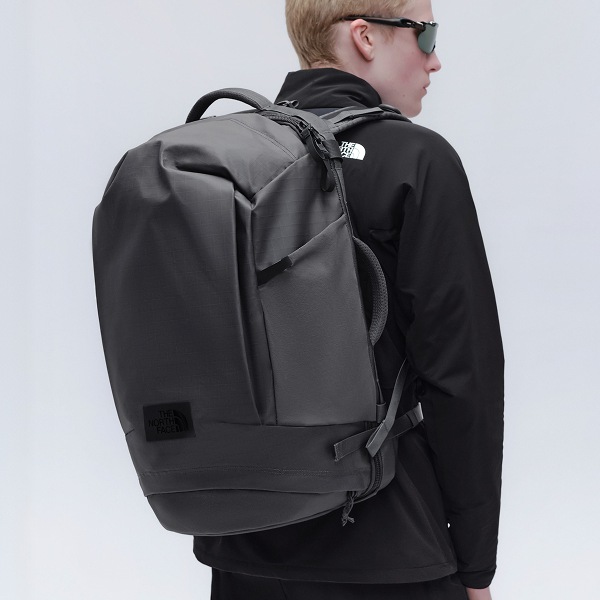 Man wearing voyager pro travel pack facing away showing the bag to the camera.