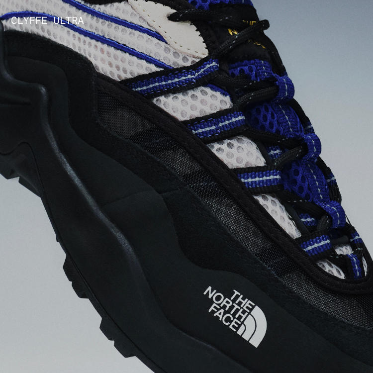 Floating product image of The North Face Clyffe Ultra Shoe in Desert Stone and TNF Blue. 