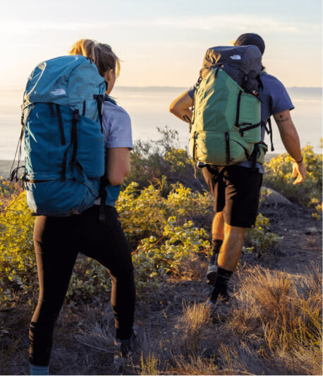 Two people hiking with backpacks
