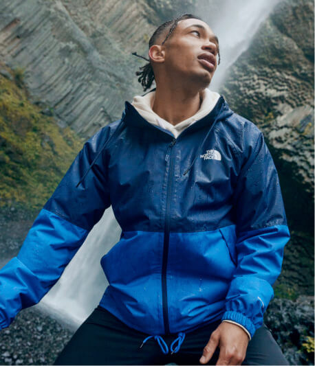 A man wearing a blue rain jacket
