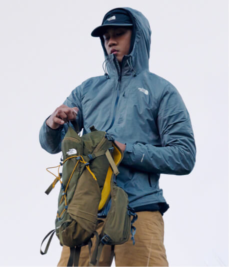 A man closing his backpack