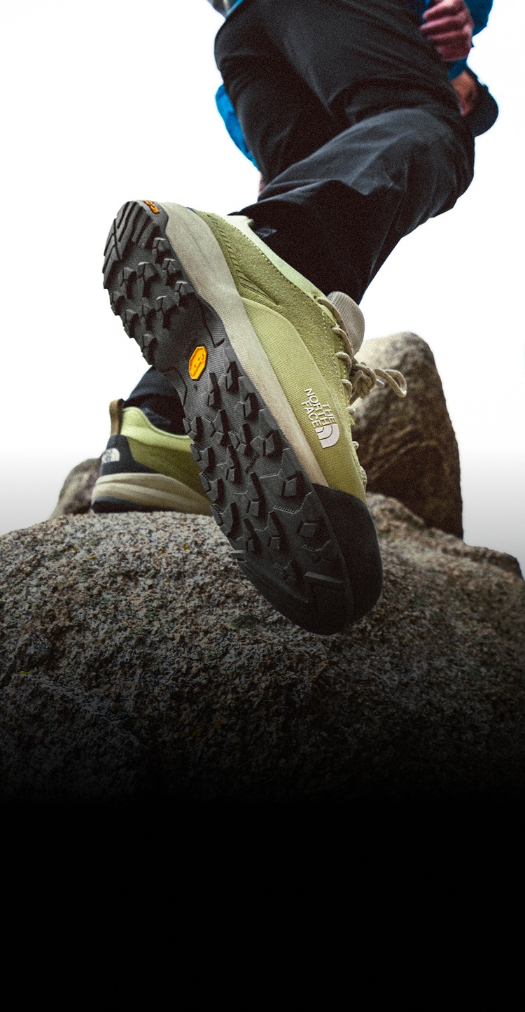Closeup of Verto shoe as the person wearing it is climbing up a mountain. 