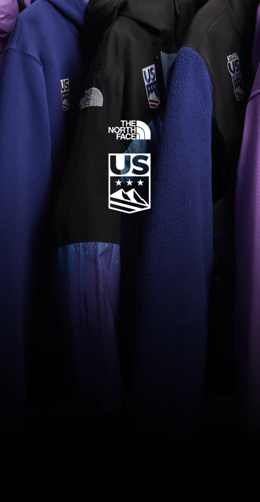 A close-up shot of The North Face x U.S. Ski & Snowboard jackets on a hanging rack.