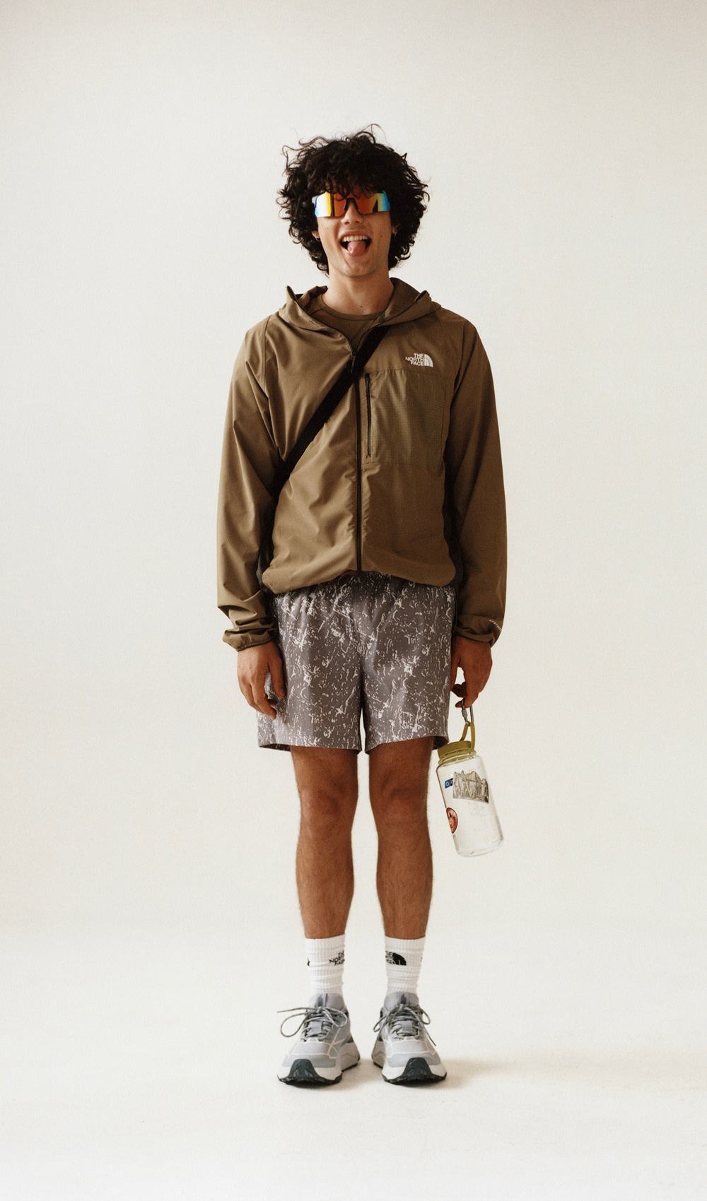 Man standing wearing a brown jacket