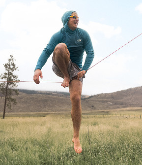 Man on a slack rope in a field