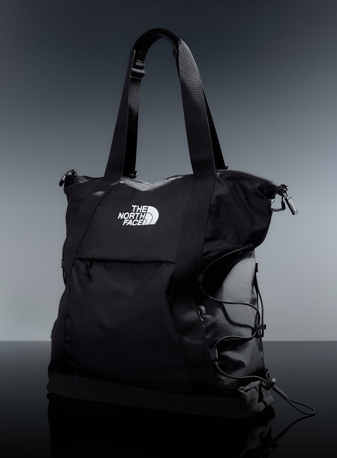 Black Borealis Backpack with patches sitting in a studio setting.