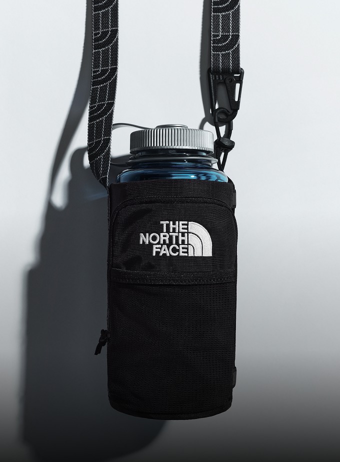 Black Borealis water bottle holder hanging in a studio setting.